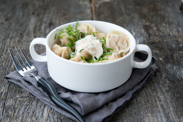 Boiled sour cream and greens pelmeni
