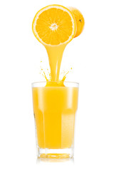 Pure orange juice pouring out from fruitin glass - obrazy, fototapety, plakaty