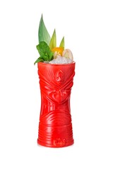 Red tiki mug decorated with rambutan, pineapple leaves and crushed ice