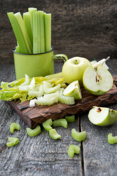 Ingredients for freshly squeezed juice from apples and a celery
