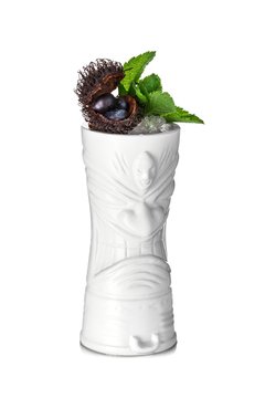 White tiki mug decorated with blueberry inside the rambutan, mint leaves and crushed ice 
