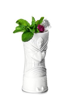 White tiki mug decorated with rose, mint leaves and bridal veil