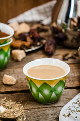 Arabian coffee with cardamon seeds - traditional coffee. Wooden background. Selective focus