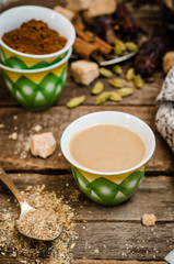 Arabian coffee with cardamon seeds - traditional coffee. Wooden background. Selective focus