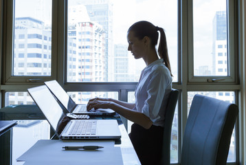 Female businesswoman working in her office.