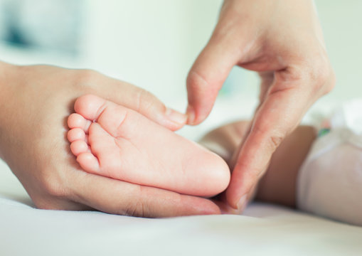 Baby feet in the mother hands

