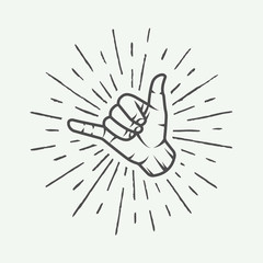 Vintage surfing shaka hand with retro sunburst.