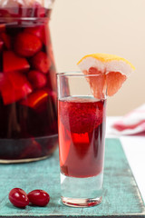 Summer fruit wine, sangria cocktail in small glass and jugful