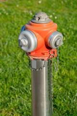 Fire hydrant. Hydrant close up. Hydrant closeup. Single fire hydrant. Hydrant fire safety. Red orange hydrant. Water hydrant. Modern hydrant. New hydrant. Contemporary hydrant. Hydrant fire plug urban