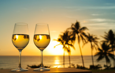 Vacation and relaxing holiday concept. Glass of wine and a beautiful sunset view.

