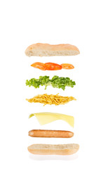 floating sandwich, hot dog sandwich with sausage, cheese, chips, lettuce and tomato