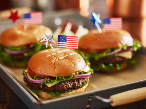 cheeseburgers with american flags for 4th of july picnic