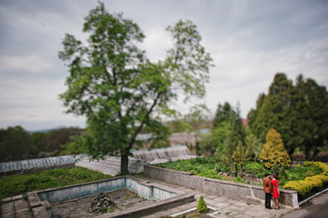 Couple hugging in love at park garden. Stylish man at velvet jac