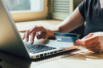 girl makes a purchase on the Internet on the computer with credit card - Powered by Adobe