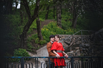 Fototapeta premium Couple hugging in love background barrier of cliff. Stylish man