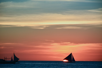 Sunset in Boracay, Philippines with a boat in the foreground