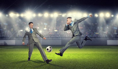 Two businessmen fight for ball