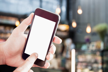 Hand holding blank screen mobile phone with blur background