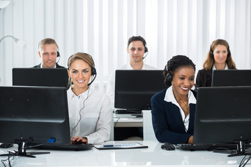 Call Center Operators Working On Computers