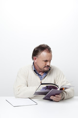 mature businessman reading a magazine.