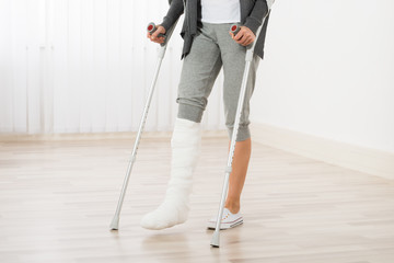 Woman Using Crutches While Walking