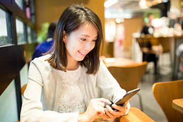 Woman use of cellphone at cafe