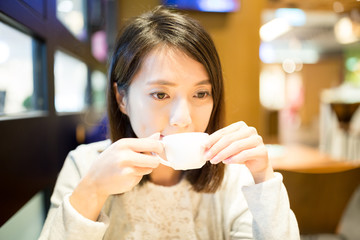 Woman having coffee in cafe shop
