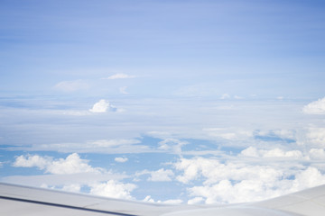 Fototapeta na wymiar Cloudy sky view from airplane cabin window