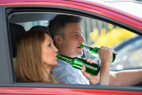 Couple Drinking Alcohol In Car