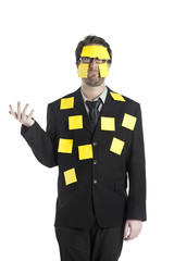 stressed businessman covered by sticky notes