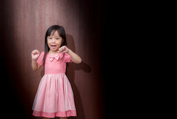 Portrait of happy little girl showing two hands