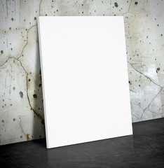 Blank white paper poster on the crack concrete wall and black ce