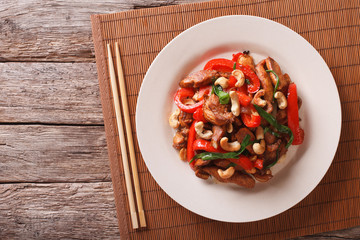 chicken pieces fried with vegetables and cashew nuts closeup. horizontal top view
