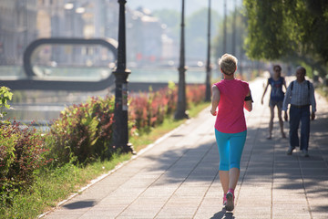 sporty woman running  on sidewalk