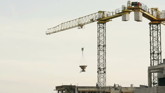 crane lifts the concrete tank on the roof