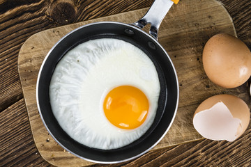 Wooden table with Fried Eggs (selective focus)