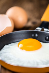 Wooden table with Fried Eggs (selective focus)