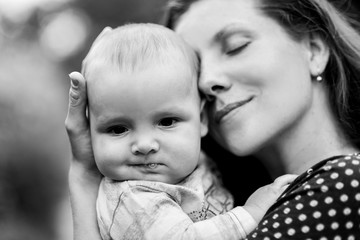 Mother embraces and kisses his little son