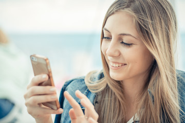 Woman using smartphone and looks at cellphone
