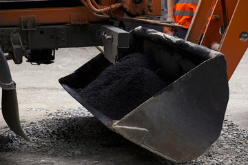 asphalt in a ladle of excavator