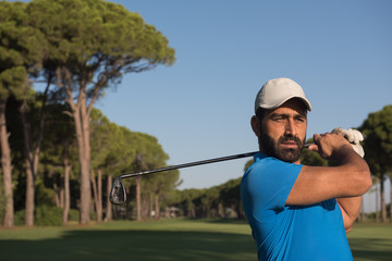 golf player hitting shot