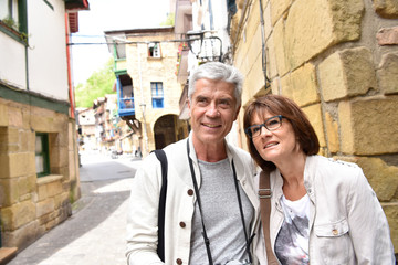 Obraz na płótnie Canvas Senior couple of tourists visiting spanish little town