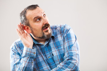 Portrait of man who is trying to hear something