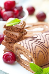 Roll with chocolate, sweet cream and cherries