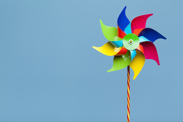 Colorful pinwheel isolated on blue background - obrazy, fototapety, plakaty