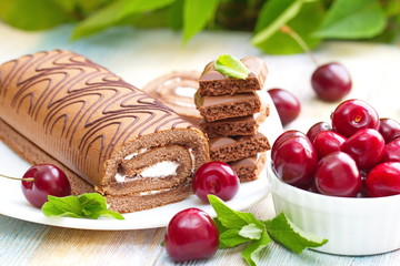 Roll with chocolate, sweet cream and cherries