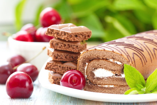 Roll with chocolate, sweet cream and cherries