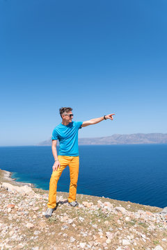 man enjoys his vacation in Greece near the sea 
