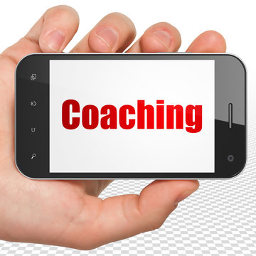Learning concept: Hand Holding Smartphone with Coaching on display