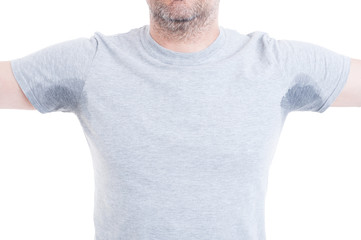 Man with arms raised and sweat stains